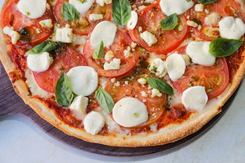 Pizza inn Margherita pizza with fresh basil and mozzarella